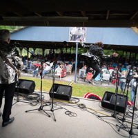 Mason Brewer taking a leap off stage right as the Kentucky Ramblers carry the tune at the 50th Dr. Ralph Stanley Hills of Home Memorial Day Bluegrass festival. Coeburn, VA. Thursday May 26th, 2022 - photo by Jeromie Stephens