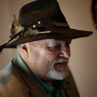 Garry Ollis talking about his beaver hat he found on a fence post 40 years ago at the 50th Dr. Ralph Stanley Hills of Home Memorial Day Bluegrass festival. Coeburn, VA. Thursday May 26th, 2022 - photo by Jeromie Stephens