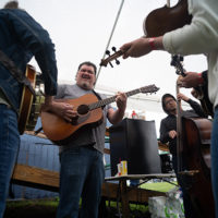 (L to R) - Zackary Vickers, Dave Adkins, Bobby Davis, and Askley Rose, warm up before their set at the 50th Dr. Ralph Stanley Hills of Home Memorial Day Bluegrass festival. Coeburn, VA. Friday May 27th, 2022 - photo by Jeromie Stephens