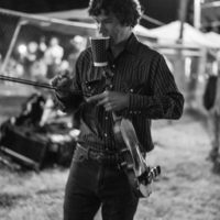 Billy Contreras with Kentucky Thunder balances everything on the way to the stage at the Dr. Ralph Stanley Hills of Home festival 2022 - photo by Jeromie Stephens