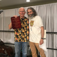 Leroy "Mack" McNees receives a Lifetime Achievement Award from Larry Maltz at ResoGAT 2022 - photo by RT Lassiter