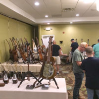 Exhibitors: Matt Leadbetter display of Phil Leadbetter's memorabilia foreground; Peter Mosco's guitars left center, and Paul Beard's table right rear at ResoGAT 2022 - photo by RT Lassiter
