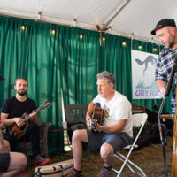 Jam session in the green room backstage (fiddle player obscured, Jake Joliff, Bryan Sutton, and Chris Douglas)  at the 2022 Grey Fox Bluegrass Festival - photo © Tara Linhardt