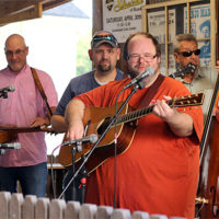 Damion Kidd, Mike Broadway, Allen Tolbert, and Mike Clements jamming at the August '22 Bluegrass Jamboree - photo by Kristin Yarbrough