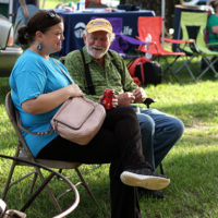 Tiffany and Coone reminisce about their days as neighbors years ago at the August '22 Bluegrass Jamboree - photo by Kristin Yarbrough