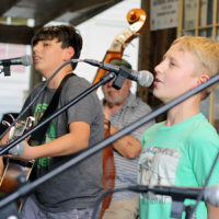 The enthusiastic and talented Albie and Joseph Gornik perform with Pine Mountain Bluegrass Band at the August '22 Bluegrass Jamboree - photo by Kristin Yarbrough