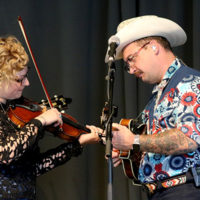 Laura Orshaw and C.J. Lewandowski with The Po' Ramblin' Boys at the 2022 North Carolina State Bluegrass Festival - photo by Laura Tate Photography
