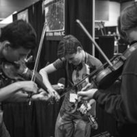 Triple fiddle jam in the exhibit hall at World of Bluegrass 2022 (9/28/22) - photo © Jeromie Stephens