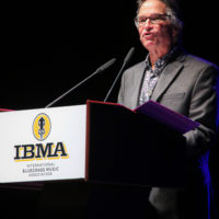 Bill Evans presents Dan Crary with a Distinguished Achievement Award at the 2022 IBMA Industry Awards luncheon - photo © Frank Baker
