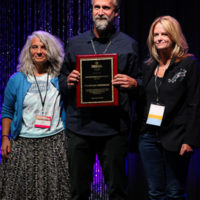 FreshGrass Foundation accepts their Distinguished Achievement award at the 2022 IBMA Industry Awards luncheon - photo © Frank Baker