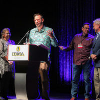 Daniel Mullins and his family accept the Event of the Year award from Tim Stafford at the 2022 IBMA Industry Awards luncheon - photo © Frank Baker
