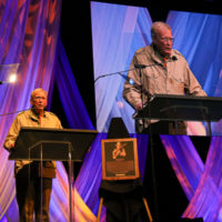 Jim Rooney lauds Peter Rowan during his Bluegrass Music Hall of Fame induction - photo © Frank Baker