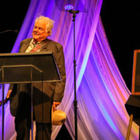 Peter Rowan speaks during his Bluegrass Music Hall of Fame induction - photo © Frank Baker