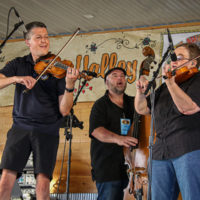 Patrick McAvinue joins Michael Cleveland for some twin fiddling at the 2022 Delaware Valley Bluegrass Festival - photo by Frank Baker
