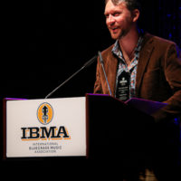 George Jackson accepts his 2022 IBMA Momentum Instrumentalist award - photo © Frank Baker