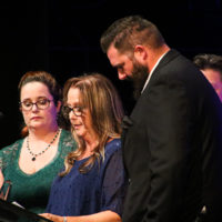 Katrina, Mollie, and BJ Moore accept the Bass Player of the Year award for their late husband and father, Jason Moore (9/29/22) - photo © Frank Baker