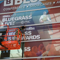 Banner goes up at the 2022 IBMA World of Bluegrass - photo © Frank Baker