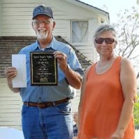 Tim Warde receives his plaque for winning first place in the Senior Division of the 2022 Fiddle Off during Laura Ingall's Wilder Days - photo courtesy of Junior Marriott