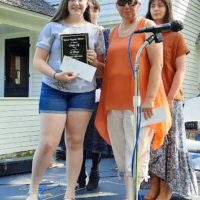 Riley Butress of Summersville, MO receives her plaque for winning first place in the Junior Division of the 2022 Fiddle Off during Laura Ingall's Wilder Days - photo courtesy of Junior Marriott