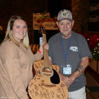 Winner of the guitar signed by all the artists at the 2022 Bluegrass Christmas in the Smokies - photo © Bill Warren