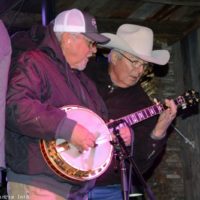 Billy Lee Cox checks on Ben Green's banjo playing with Lorraine Jordan & Carolina Road at Ole Smokey Moonshine (11/16/22) - photo © Bill Warren