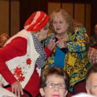Lorraine Jordan finds Sue Lee in the crowd at Bluegrass Christmas in the Smokies - photo © Bill Warren
