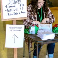 New promoter Miranda Smith staffs the ticket table at the 2023 Highfalls Fiddler's Convention in Robbins, NC - photo by Gary Hatley
