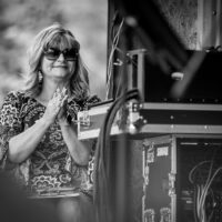 MC Cindy Baucom enjoys the music at the Tony Rice Memorial Day Musicfest at Camp Springs (5/26/23) - photo © Jeromie Stephens