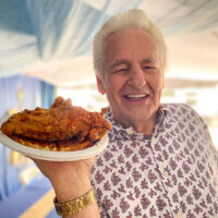 Del McCoury serving up chicken and waffles at DelFest 2023 - photo © P Chorney