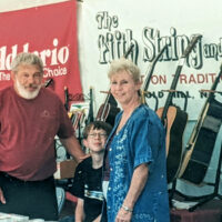 Hoppy, Shaun, and Vivian Hopkins in the Fifth String and Co. booth