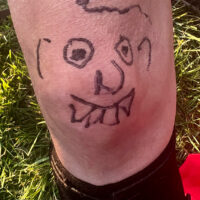Drawing Little Roy made on Buddy Michaels knee at the 2023 Willow Oak Bluegrass Festival - photo © Gary Hatley