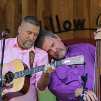 Tender moment between Troy Pope and Scott Burgess at the 2023 Willow Oak Bluegrass Festival - photo © Laura Tate Photography