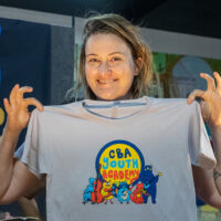 Director Kimber Ludiker with her Youth Academy T-shirt at the 2023 CBA Father's Day Festival - photo © Robin Frenette