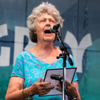 Ginger Smith of Ginger's Breakfast Cafe at Grey Fox, who has been with the festival since its beginning, read a beautiful poem she wrote for Mary Doub - photo © Tara Linhardt