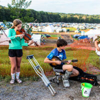 Students busking in the campground and raising money for the Kids Academy on Saturday at Grey Fox 2023 - photo © Tara Linhardt