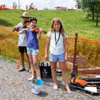 Students busking in the campground and raising money for the Kids Academy on Saturday at Grey Fox 2023 - photo © Tara Linhardt