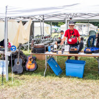 Scott Farrar with the Silent Raffle prizes table, with proceeds supporting Kids Academy at the 2023 Grey Fox Bluegrass Festival - photo © Tara Linhardt