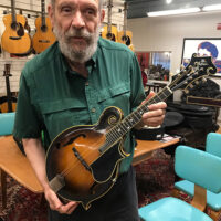 George Gruhn at Gruhn Guitars with a valuable antique Gibson mandolin - photo © Alan Goforth
