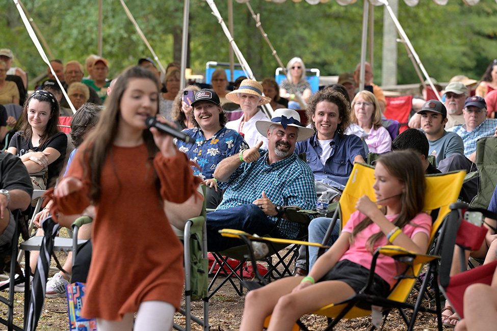 Caroline Williamson with Williamson Branch heads into the audience at the 2023 Carolina Bible Camp Bluegrass Festival - photo © David Johnson