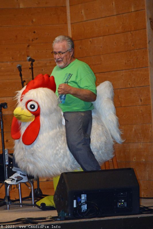 MC Freddie Smith rides the chicken at the 2023 Dumplin Valley Bluegrass Festival - photo © Bill Warren