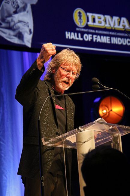 Sam Bush accepts induction into the Bluegrass Music Hall of Fame at the 2023 IBMA Bluegrass Music Awards - photo © Frank Baker