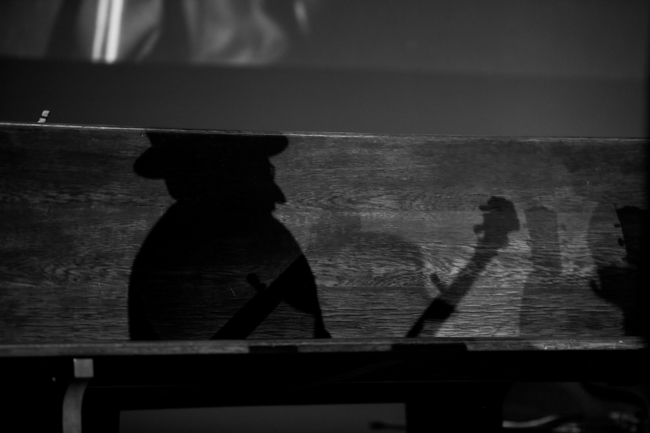 Charlie Cushman's shadow at the 100th Birthday Celebration for Earl Scruggs at The Ryman Auditorium (1/6/24) - photo © Bryce LaFoon