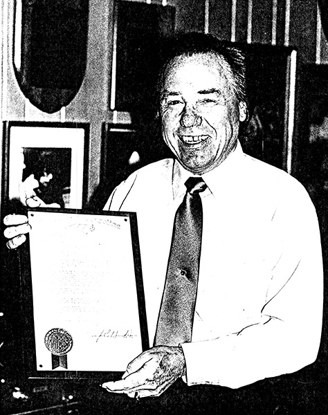 Earl Scruggs with a proclamation from the state of North Carolina marking his 60th birthday