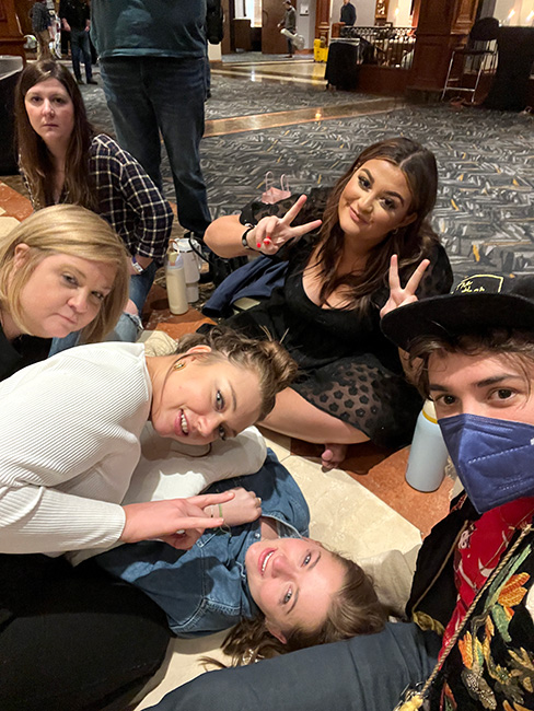 Maddie Dalton, surrounded by friends and bandmates as she awaits medical attention in the Music City Sheraton lobby during SPBGMA (1/27/24)