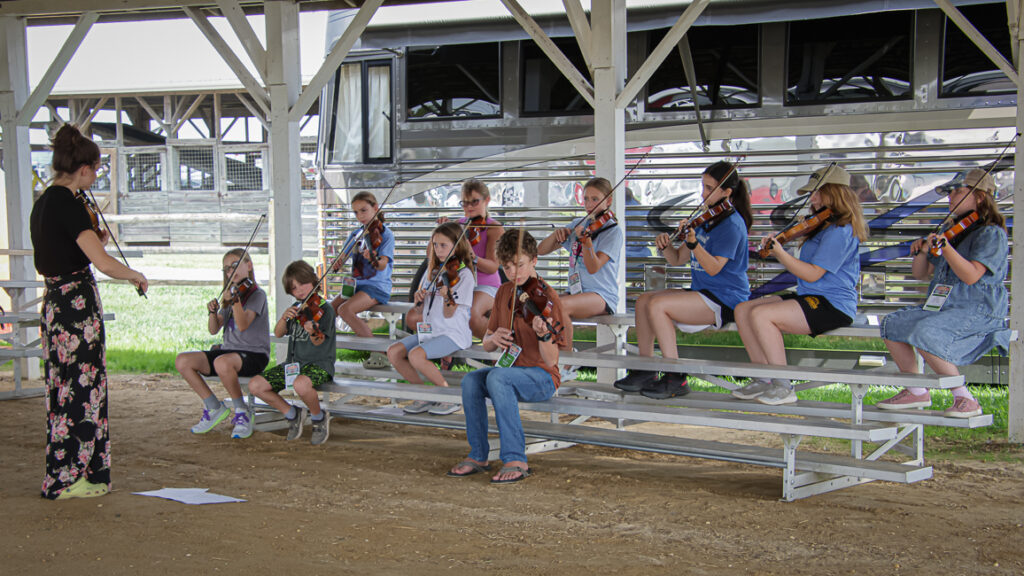 Katelynn Casper leads fiddle students at the Kids Academy at the 2024 Delaware Valley Bluegrass Festival - photo © Frank Baker