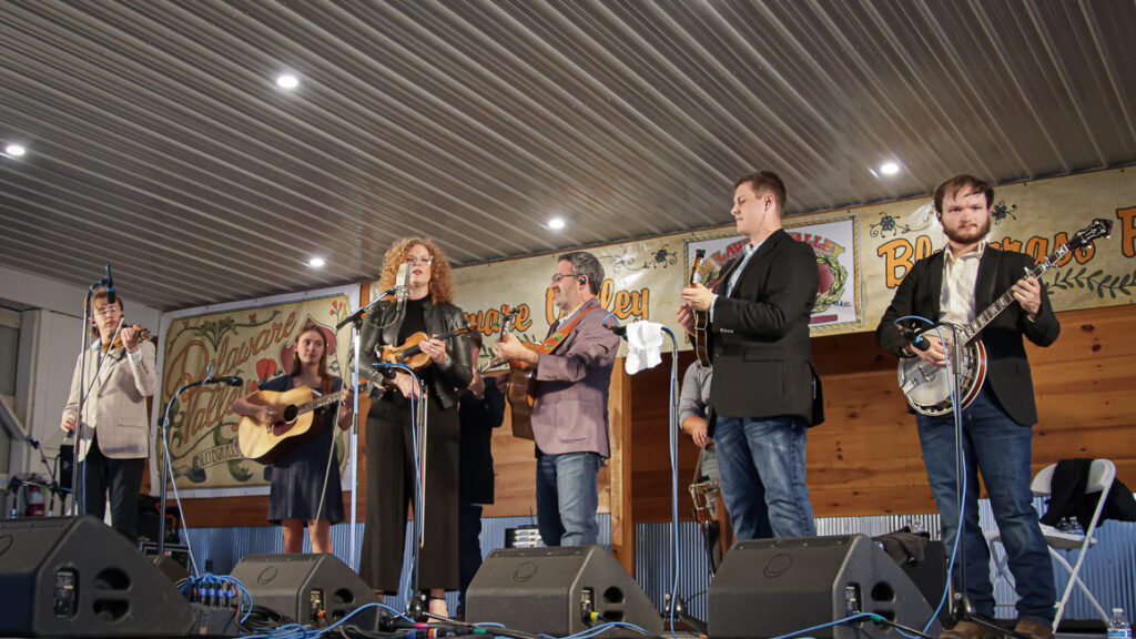 Becky Buller and ETSU Professor Dan Boner with the East Tennessee State University Pride Band at the 2024 Delaware Valley Bluegrass Festival - photo © Frank Baker