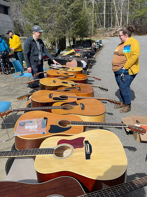 Guitars lined up at free instrument distribution by Woodsongs in Asheville, NC (3/9/25)