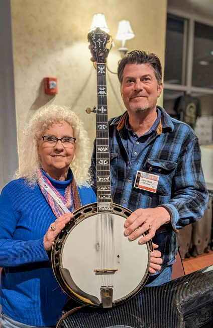 Vivian Pennington Hopkins with JD Crowe’s banjo, owned and played by 501 Central’s David Gilreath at Bluegrass First Class '26 - photo © Vivian Pennington Hopkins
