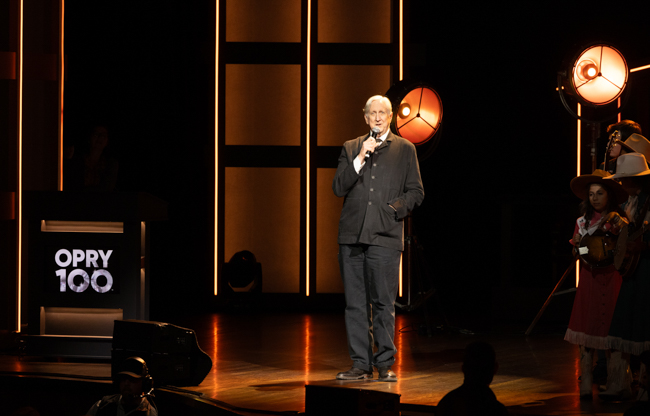 T Bone Burnett addresses the audience at the Grand Ole Opry for the 25th Anniversary of the O Brother, Where Art Thou? soundtrack (2/28/26) - photo © Grand Ole Opry