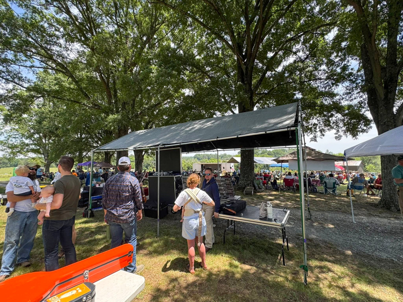 Jesse Brock greets fans at the Authentic Unlimited table at Gospel on the Farm 2026 - photo courtesy of The Gospel Plowboys